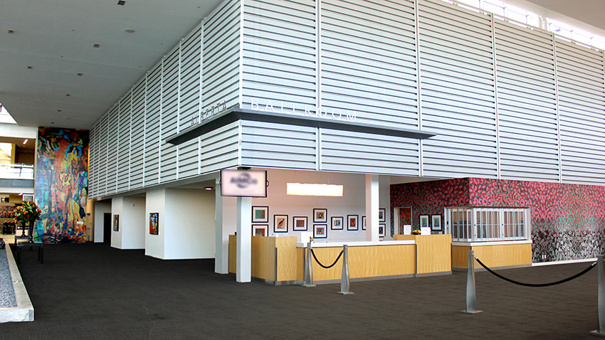 EXPO Art Pavillion web Interior of the Edmonton EXPO Centre with artwork from the Nina on walls throughout the space.