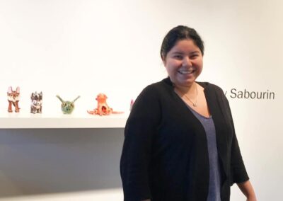 Holly Sabourin standing in front of her work in a gallery