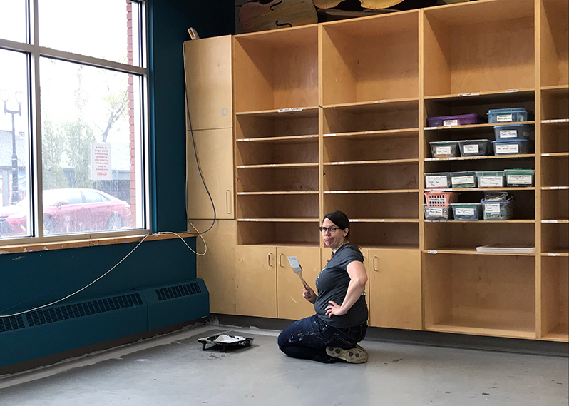 Cynthia painting the floors of the new fabric studio