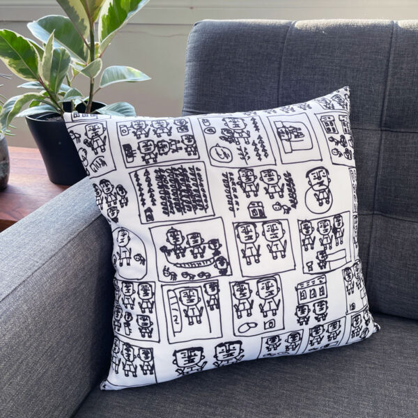 White square pillow with black figures drawn by Kim Hung Ho