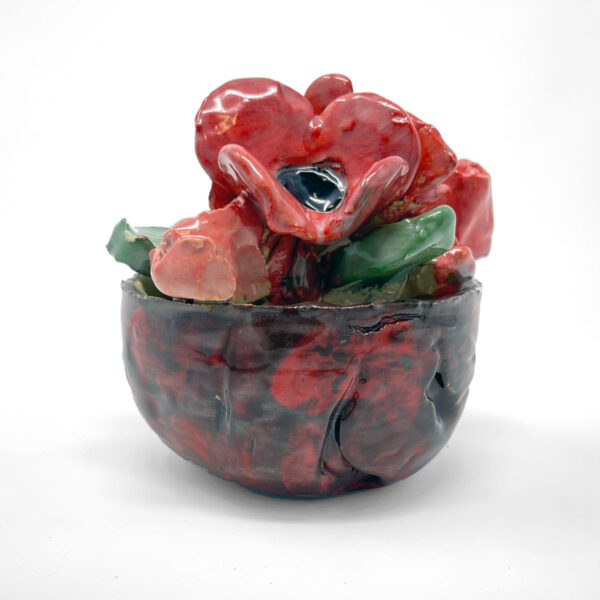 Ceramic sculpture of red flowers in a brown and red bowl