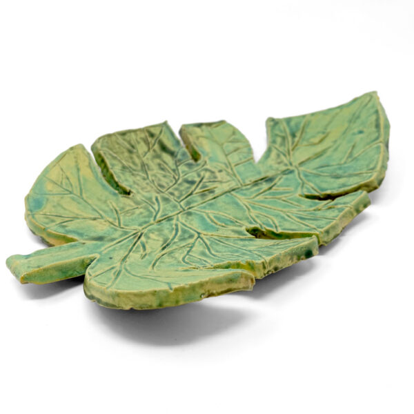 Green ceramic plate that looks like a monstera leaf