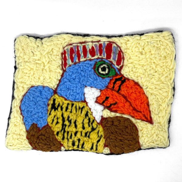 Needlework of a colourful bird on a light yellow background