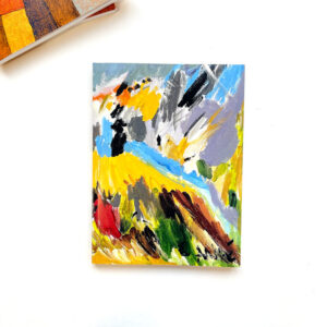 Notebook with brightly coloured abstract painting on the cover