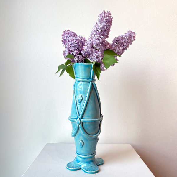 Blue vase with lilacs in it