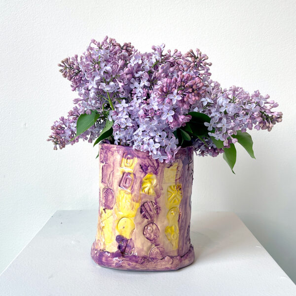 Photo of purple and yellow vase with lilacs