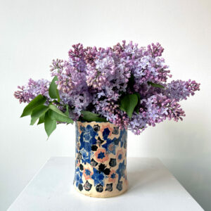 Ceramic vase full of lilacs