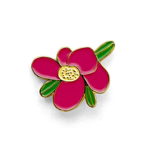 Enamel pin of a pink wild rose outlined in gold metal