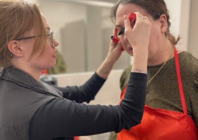 Sophie getting her makeup done by Rin backstage