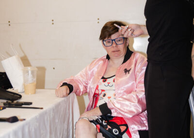 Carrie getting her makeup done by an MC College student
