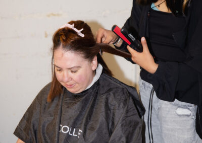 Sophie getting her hair done by an MC College student