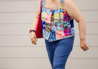 Brenda modelling a shirt, pants, and hat made by Collette