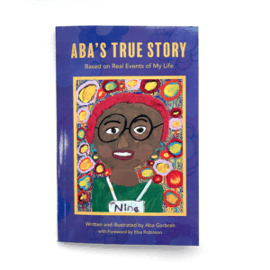 Photo of the front cover of 'Aba's True Story'. The book is purple with a painted self portrait of Aba